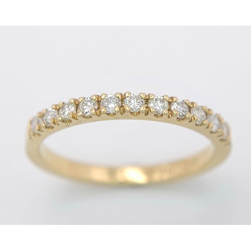 670 - An 18 K yellow gold ring with a band of round cut diamonds, size: N, weight: 2.4 g.