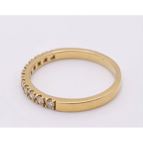 670 - An 18 K yellow gold ring with a band of round cut diamonds, size: N, weight: 2.4 g.