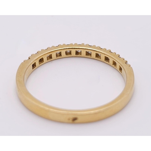 670 - An 18 K yellow gold ring with a band of round cut diamonds, size: N, weight: 2.4 g.