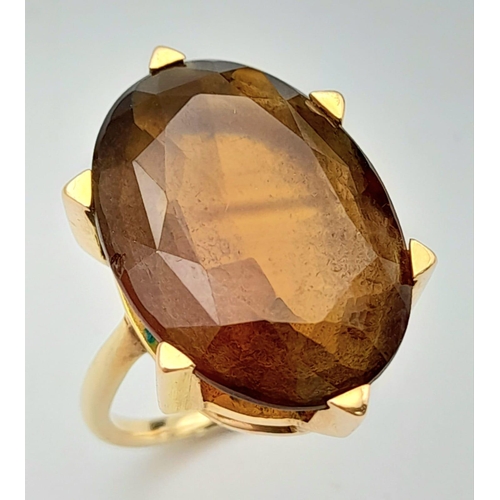 771 - A 9K Yellow Gold (tested) Smoky Quartz Ring. 12ct central oval smoky quartz. 6.73g total weight. Siz... 