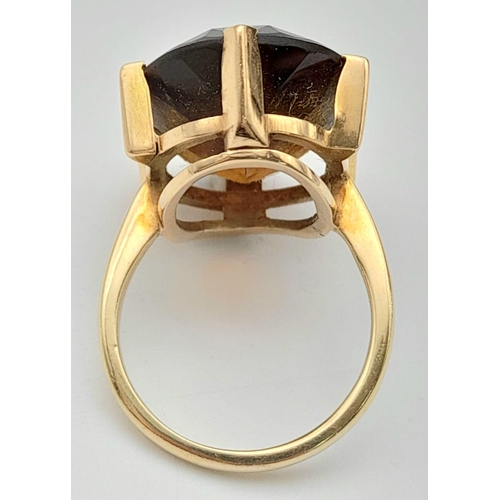 771 - A 9K Yellow Gold (tested) Smoky Quartz Ring. 12ct central oval smoky quartz. 6.73g total weight. Siz... 