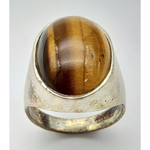 792 - A vintage sterling silver tiger eye solitaire ring with full London hallmarks, 1974. Total weight 7.... 