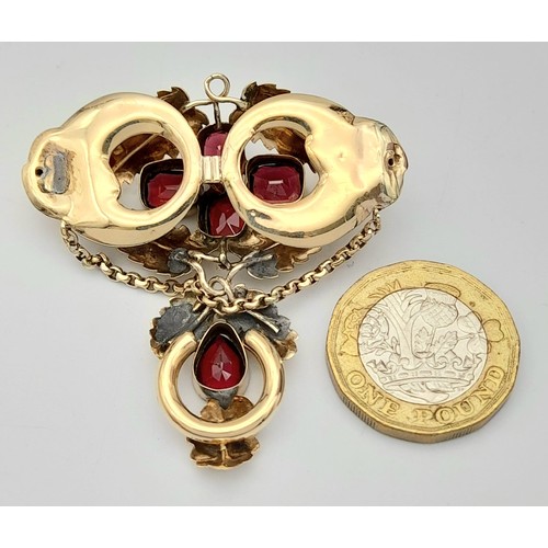 960 - A 9K Gold (tested) and Garnet Hanging Pendant. Asian inspired. 5cm. 8.3g total weight.