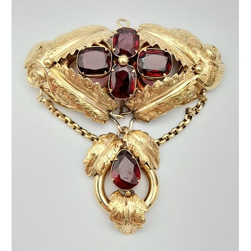 960 - A 9K Gold (tested) and Garnet Hanging Pendant. Asian inspired. 5cm. 8.3g total weight.