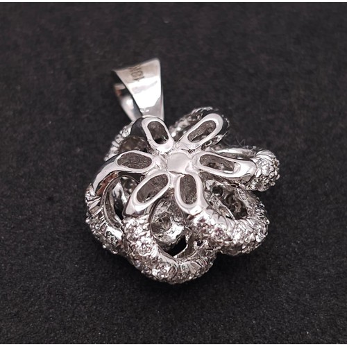 930 - An 18K White Gold, Black and White Diamond Decorative Floral Pendant. 25mm. 4.65g weight.