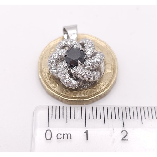 930 - An 18K White Gold, Black and White Diamond Decorative Floral Pendant. 25mm. 4.65g weight.