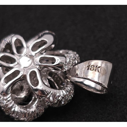 930 - An 18K White Gold, Black and White Diamond Decorative Floral Pendant. 25mm. 4.65g weight.