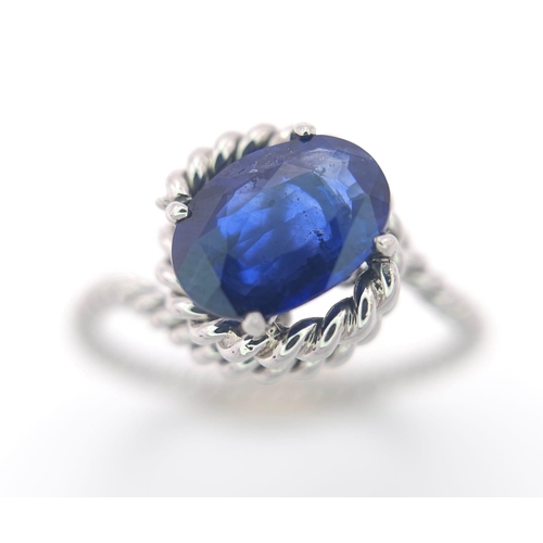 967 - A Twisted Platinum and 2ct Sapphire Ring. Size M. 4g total weight.