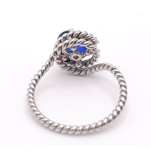 967 - A Twisted Platinum and 2ct Sapphire Ring. Size M. 4g total weight.