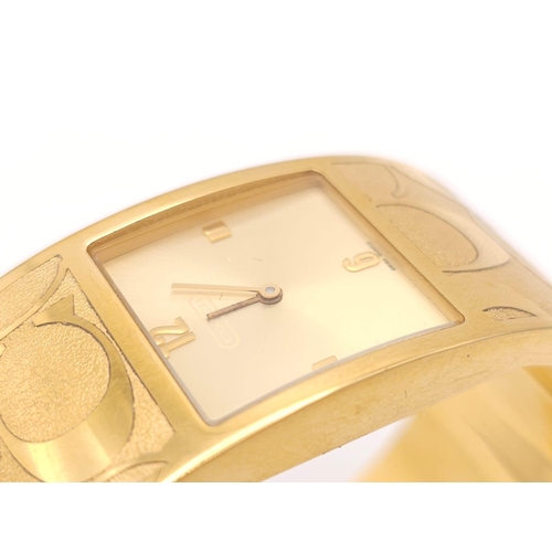 977 - A CLIP BANGLE FASHION WATCH BY COACH , WITH QUARTZ MOVEMENT AND SQUARE GOLD TONE DIAL . COMES WITH O... 