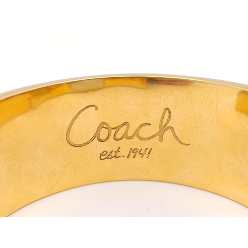 977 - A CLIP BANGLE FASHION WATCH BY COACH , WITH QUARTZ MOVEMENT AND SQUARE GOLD TONE DIAL . COMES WITH O... 