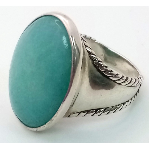 1344 - A Sterling Silver Blue Agate Oval Ring. Size T. 13.3g weight