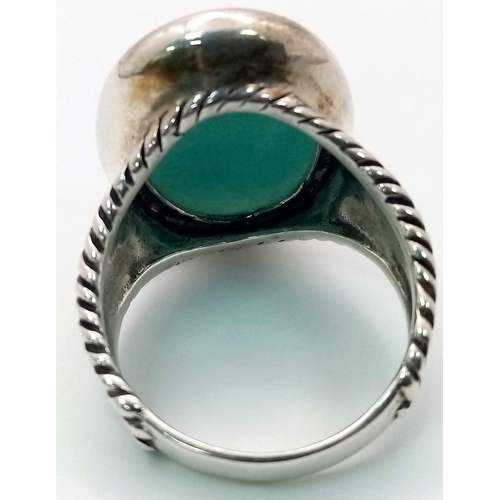 1344 - A Sterling Silver Blue Agate Oval Ring. Size T. 13.3g weight