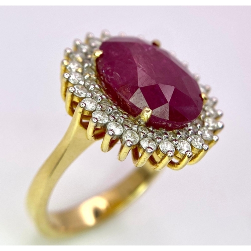 909 - An 18K Ruby and Diamond Ring. Central oval cut 7.75ct ruby with a diamond surround. Comes with a IGI... 