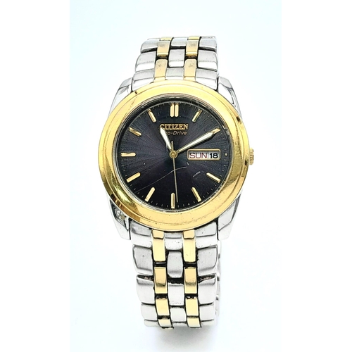 1193 - A Vintage Citizen Eco Drive Gents Watch. Two tone bracelet and case - 35mm. Black dial with day/date... 