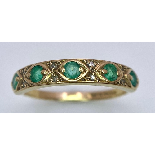 1264 - A 9K GOLD RING WITH EMERALD AND DIAMONDS .  1.6gms   size M