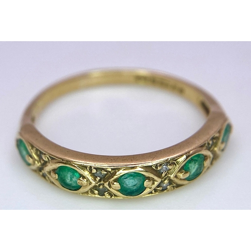 1264 - A 9K GOLD RING WITH EMERALD AND DIAMONDS .  1.6gms   size M