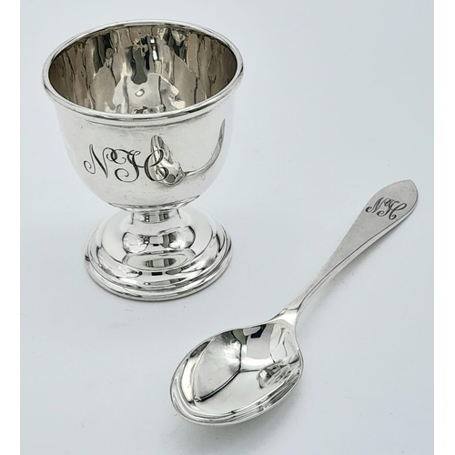 1299 - A Vintage Sterling Silver Egg Cup and Spoon. Birmingham hallmarks. 46g total weight.