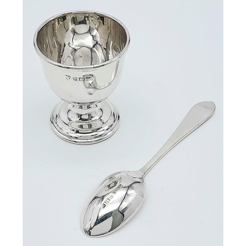 1299 - A Vintage Sterling Silver Egg Cup and Spoon. Birmingham hallmarks. 46g total weight.