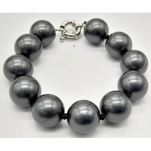 1167 - Two Stylish South Sea Pearl Shell Bracelets. Dark grey and white. Both 14mm beads. 17 and 18cm lengt... 