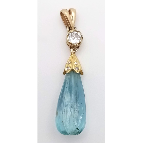 1339 - A CARVED TEAR DROP AQUAMARINE AND DIAMOND PENDANT SET IN HIGH CARAT GOLD .   1.9gms