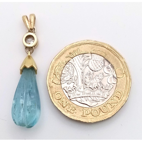 1339 - A CARVED TEAR DROP AQUAMARINE AND DIAMOND PENDANT SET IN HIGH CARAT GOLD .   1.9gms