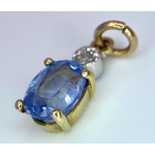 1360 - A NATURAL UNTREATED SAPPHIRE AND DIAMOND PENDANT .    1.0gms