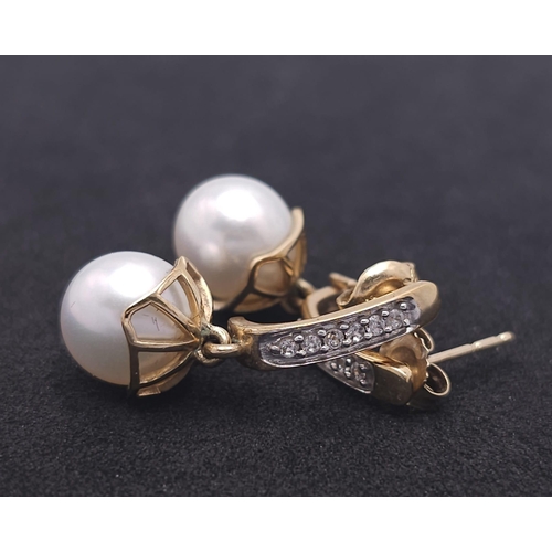 1143 - A Pair of 9K Yellow Gold, Pearl and Diamond Earrings. 4g total weight.