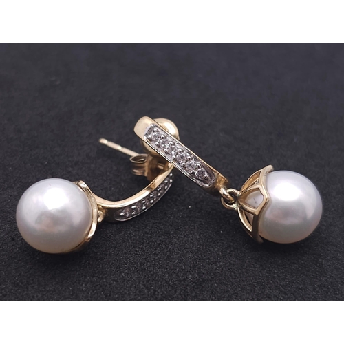 1143 - A Pair of 9K Yellow Gold, Pearl and Diamond Earrings. 4g total weight.