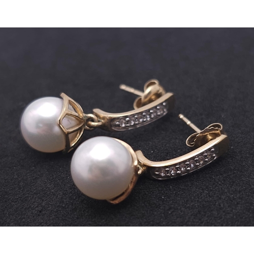 1143 - A Pair of 9K Yellow Gold, Pearl and Diamond Earrings. 4g total weight.