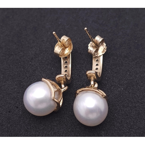 1143 - A Pair of 9K Yellow Gold, Pearl and Diamond Earrings. 4g total weight.