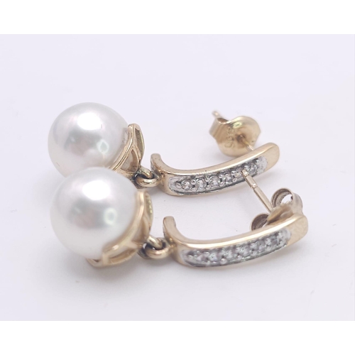 1143 - A Pair of 9K Yellow Gold, Pearl and Diamond Earrings. 4g total weight.