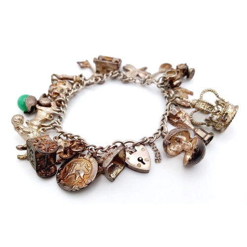 1155 - A 925 silver multiple charms bracelet include Royal crown, racket, etc. Total weight 52.6G. Please s... 