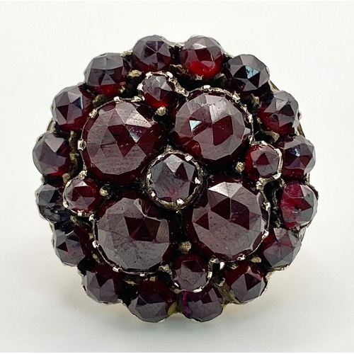 1237 - A LARGE GARNET CLUSTER RING IN 9K GOLD .  9.9gms   size M