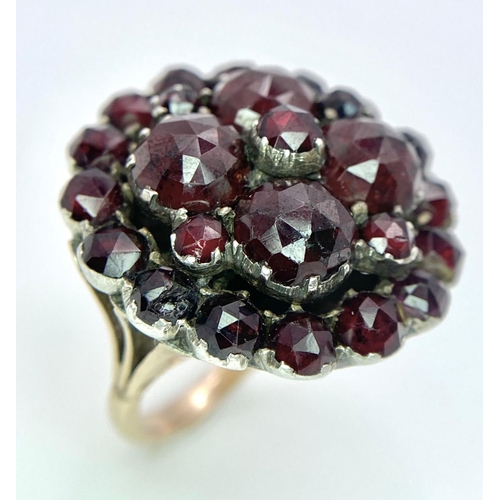 1237 - A LARGE GARNET CLUSTER RING IN 9K GOLD .  9.9gms   size M