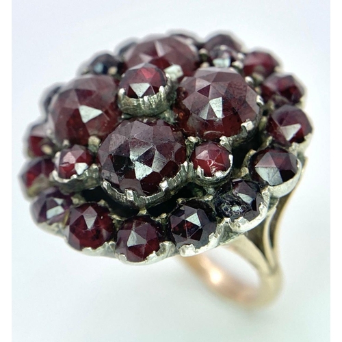 1237 - A LARGE GARNET CLUSTER RING IN 9K GOLD .  9.9gms   size M