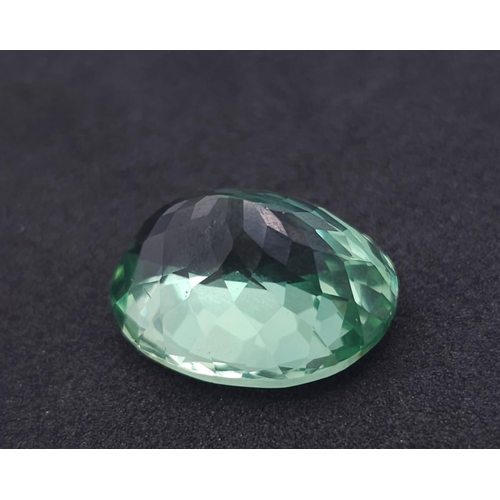 1303 - A Mesmerising 26ct Green Hiddenite Gemstone. Oval cut and well faceted. No visible marks of inclusio... 