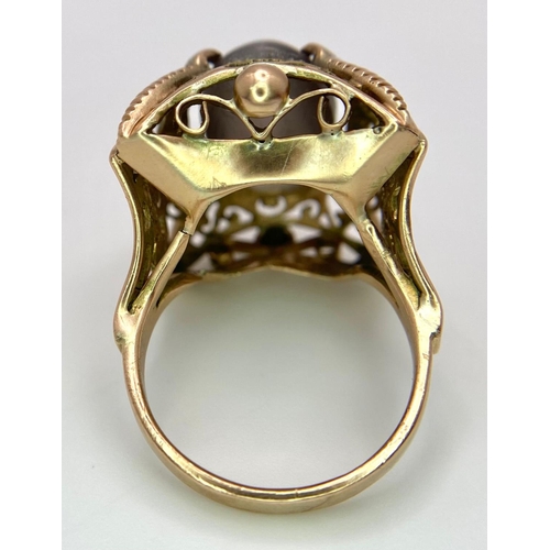 1377 - AN EXQUISITE 10ct OVAL CATSEYE STONE SET IN A REGAL 14K GOLD RING .   8.6gms   size M