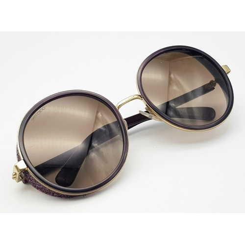 1383 - A Jimmy Choo ladies sunglasses in original snake skin case.