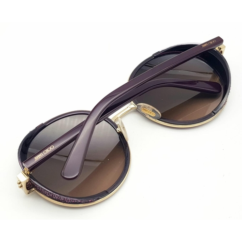 1383 - A Jimmy Choo ladies sunglasses in original snake skin case.