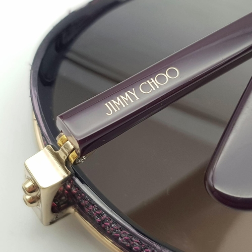 1383 - A Jimmy Choo ladies sunglasses in original snake skin case.