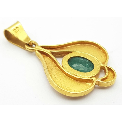 17 - A 22K Yellow Gold and Emerald Pendant. Decorative leaf pattern with a central oval emerald. 4cm. 4.8... 