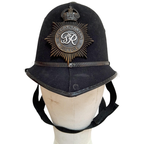 347 - A British Metropolitan Police Helmet. Complete with original badge.