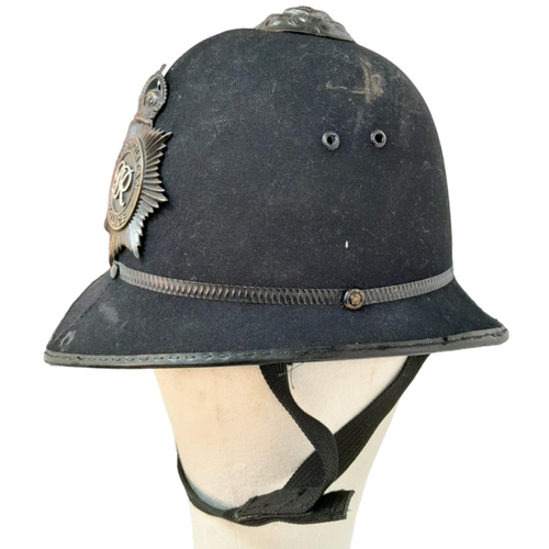 347 - A British Metropolitan Police Helmet. Complete with original badge.