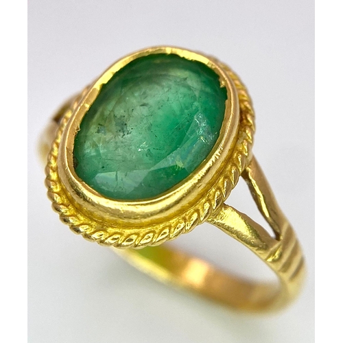 57 - A 21K (tested) Green Emerald Ring. Central oval cut emerald. 
Size H. 3.15g weight.