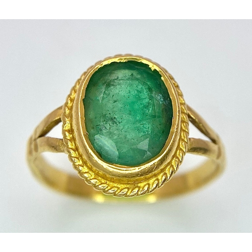 57 - A 21K (tested) Green Emerald Ring. Central oval cut emerald. 
Size H. 3.15g weight.