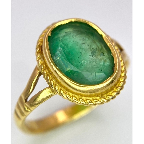 57 - A 21K (tested) Green Emerald Ring. Central oval cut emerald. 
Size H. 3.15g weight.