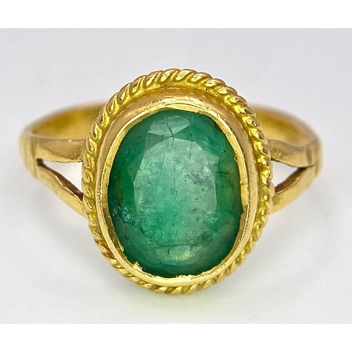 57 - A 21K (tested) Green Emerald Ring. Central oval cut emerald. 
Size H. 3.15g weight.