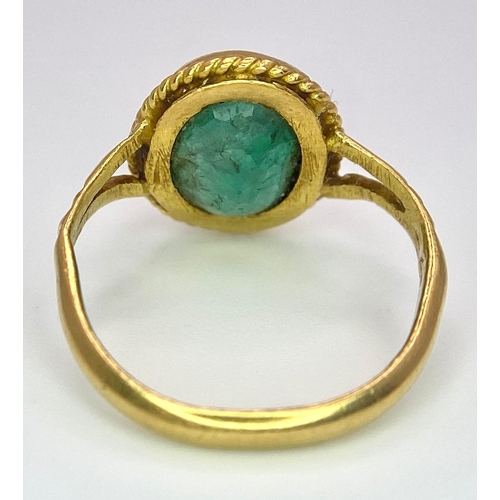 57 - A 21K (tested) Green Emerald Ring. Central oval cut emerald. 
Size H. 3.15g weight.