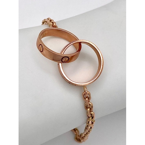 6 - A 9K Rose Gold Entwined Ring Bracelet. 18cm length. 10.7g weight.